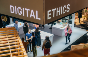 People wandering around a gallery style space named 'Digital Ethics'