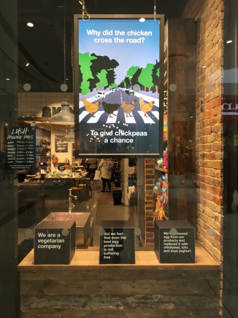 A Lush shop window featuring information about Lush going egg-free.