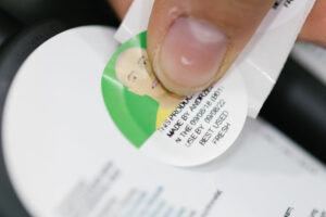 A close up image of a Lush batch code sticker being placed on a product.